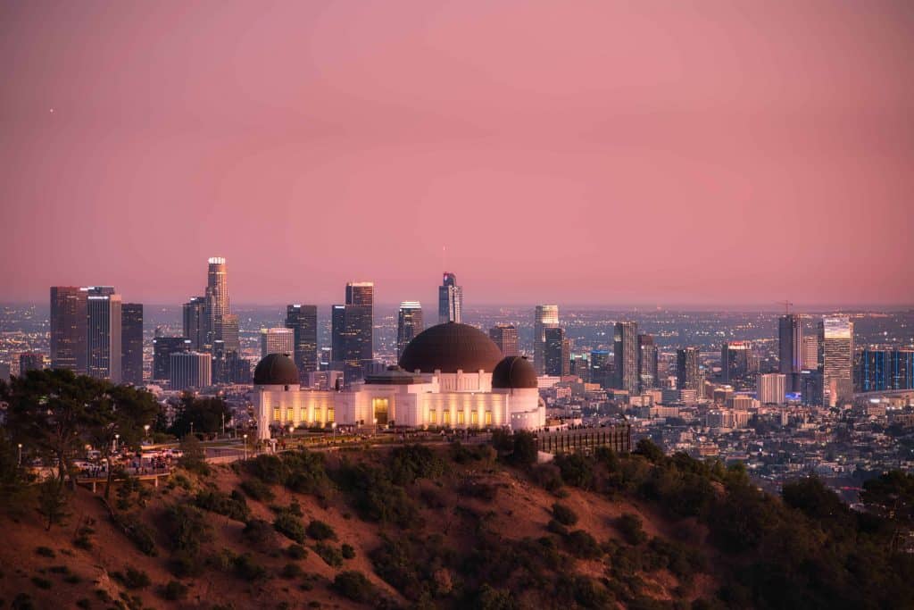 The Griffith Observatory at dusk overlooking los angeles skyline