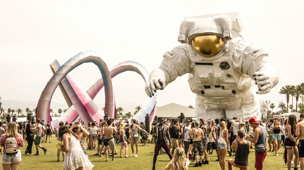 Big Astronaut balloon floating over Coachella festival attendees