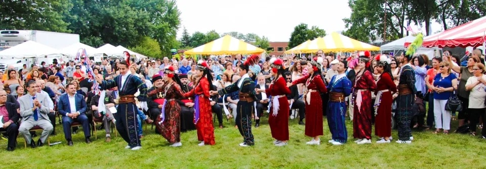 Dance troupe performing for the crowd in open grounds at the Annual Assyrian Food Festival