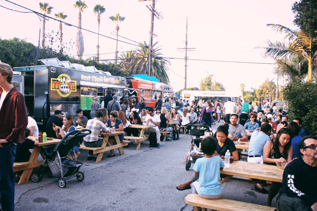 People eating at the First Friday Food Truck Fest Abbot Kinney Rd