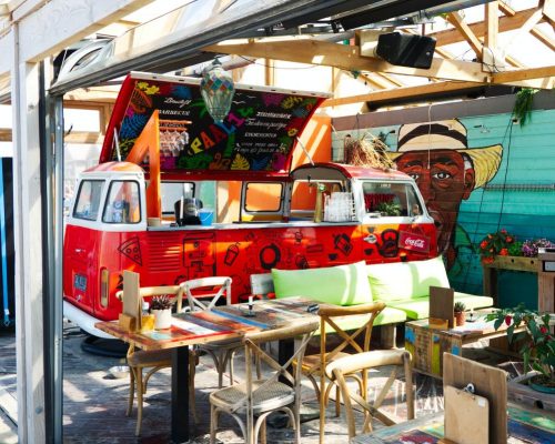 colorful food truck with cozy sofa at lunch time